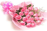 Pink roses in a Bouquet with ribbon and wrap.